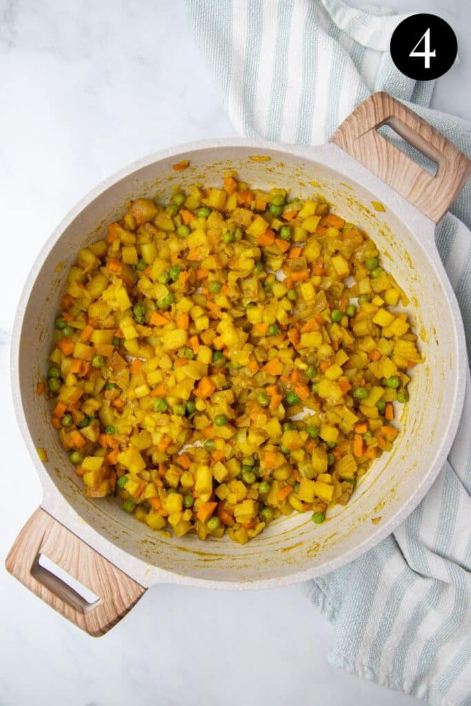 cooked vegetable filling in a white pan.