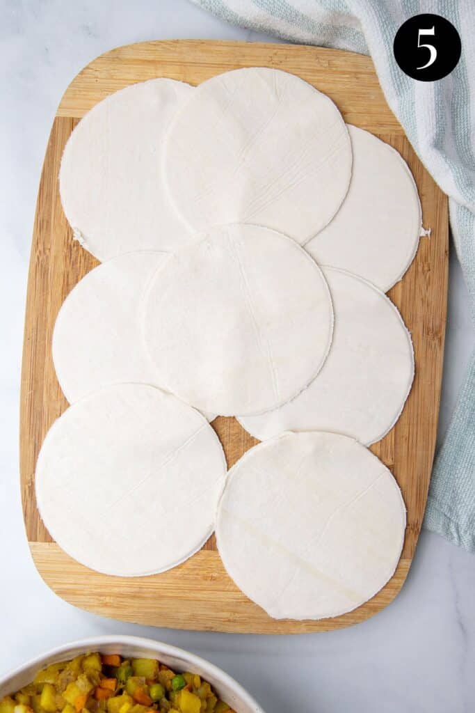puff pastry circles on a wooden board.