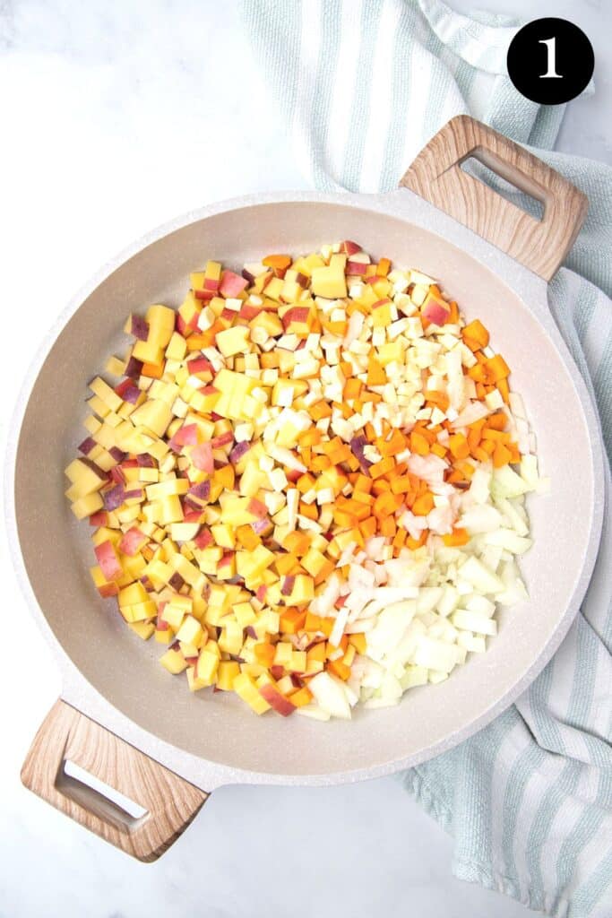 diced vegetables in a white pan.