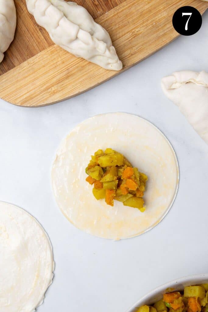 vegetable filling on a pastry circle.