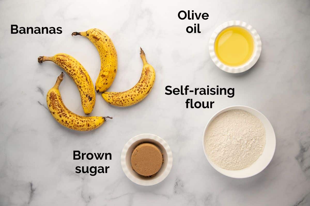 all ingredients for banana bread, laid out on a table.