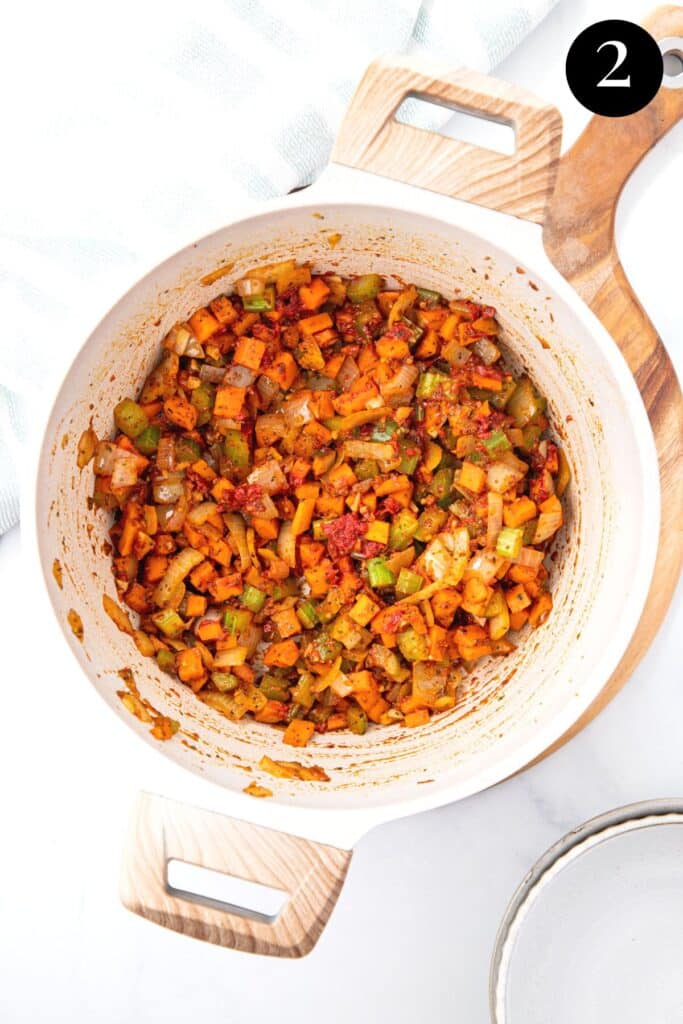 vegetables and tomato paste in a pot.