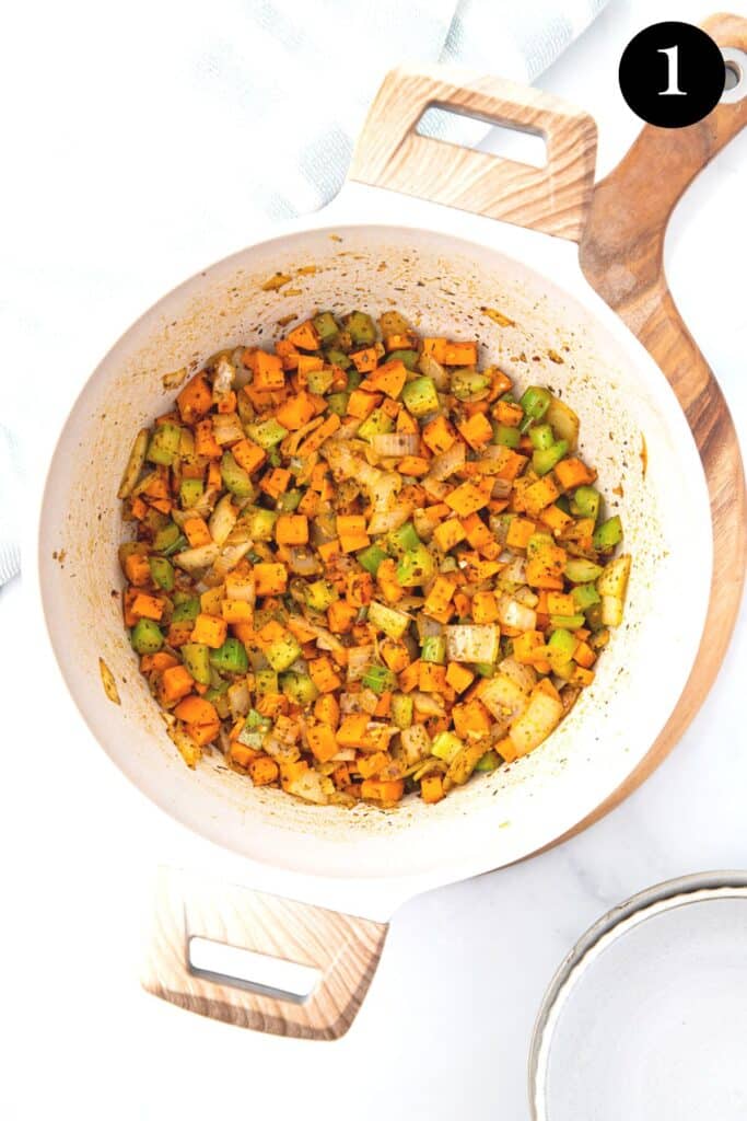 celery, carrot and onion frying in a pot.