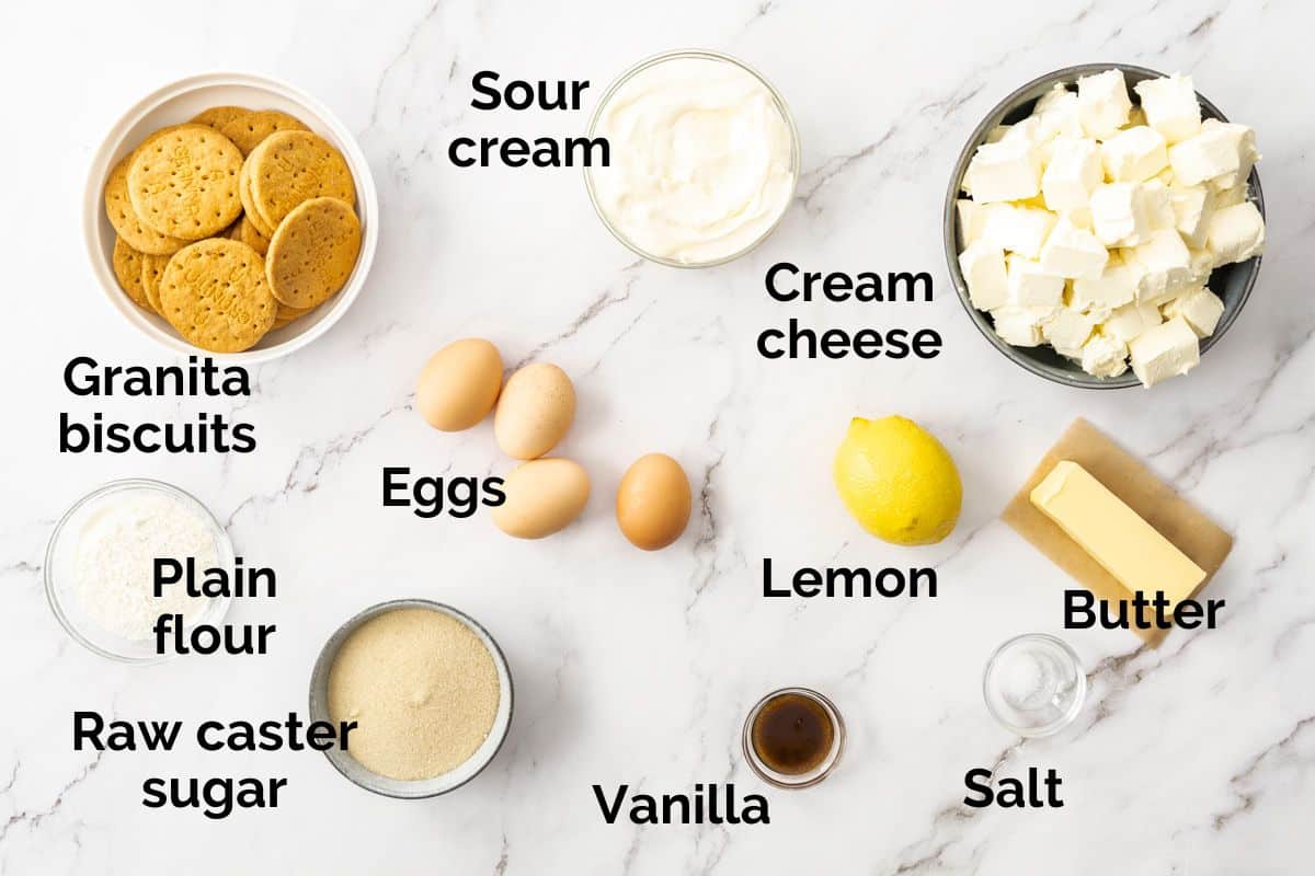 all ingredients for New York cheesecake, laid out on a table.