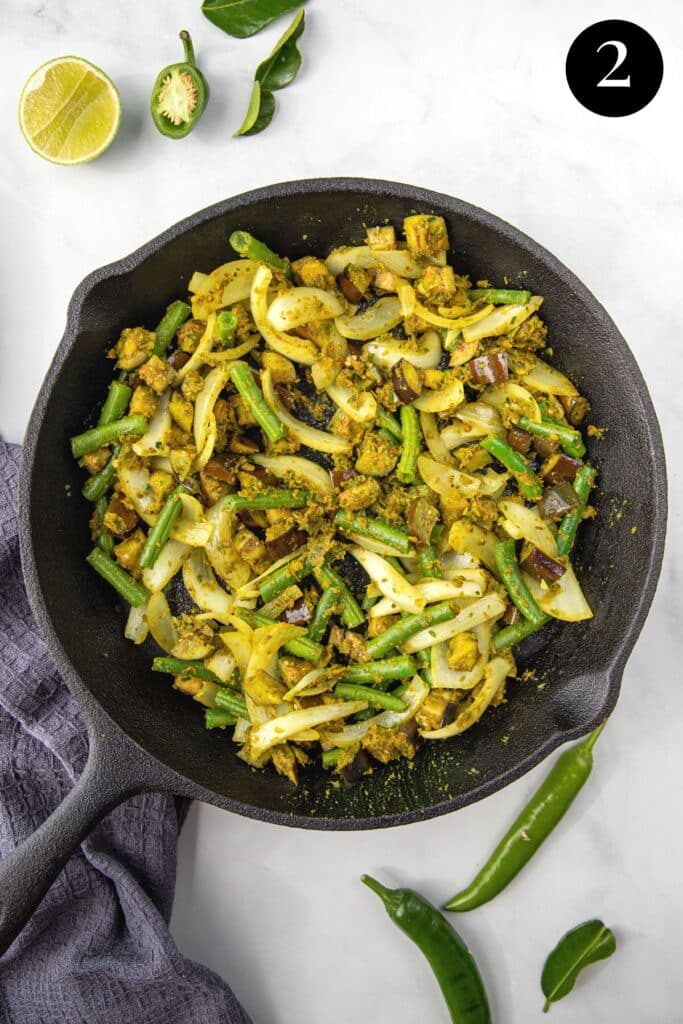 vegetables and green curry paste in a pan.