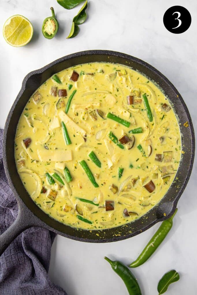 green curry sauce in a pan with vegetables.