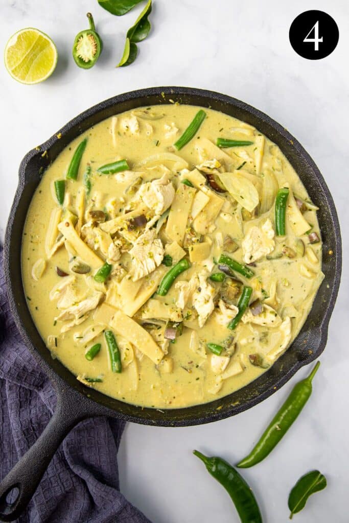 finished green chicken curry in a pan.