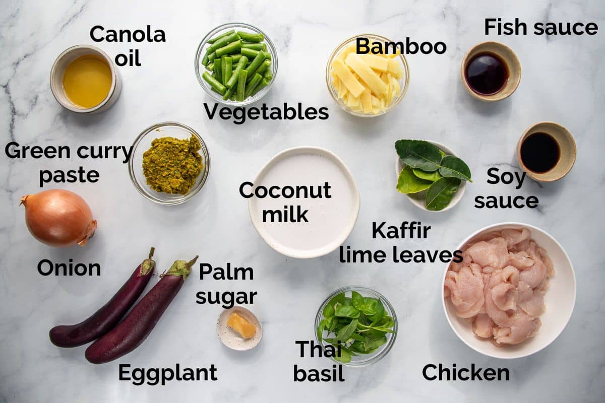 all ingredients for Thai green chicken curry, laid out on a table.