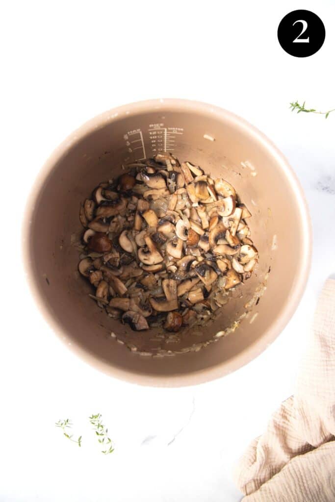 browned mushrooms in a slow cooker pot.