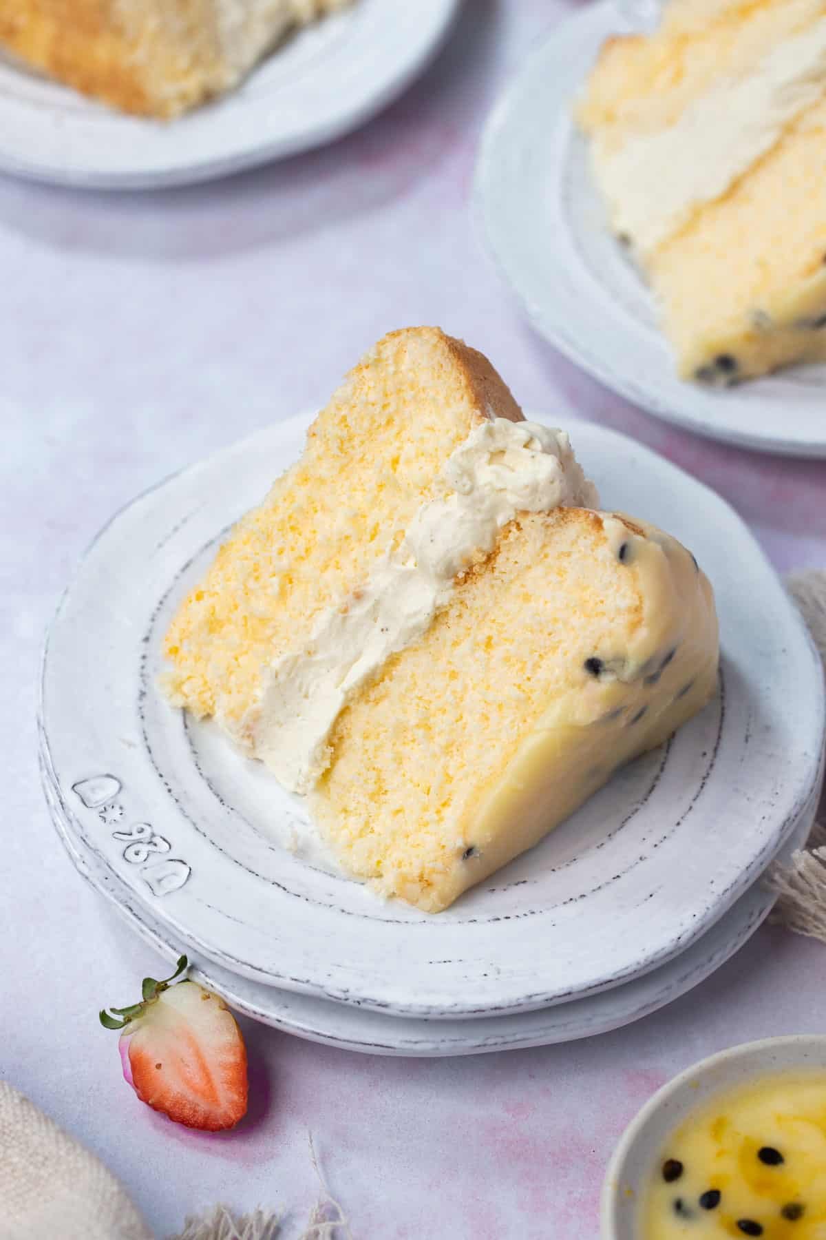 a slice of sponge cake on a plate with whipped cream.