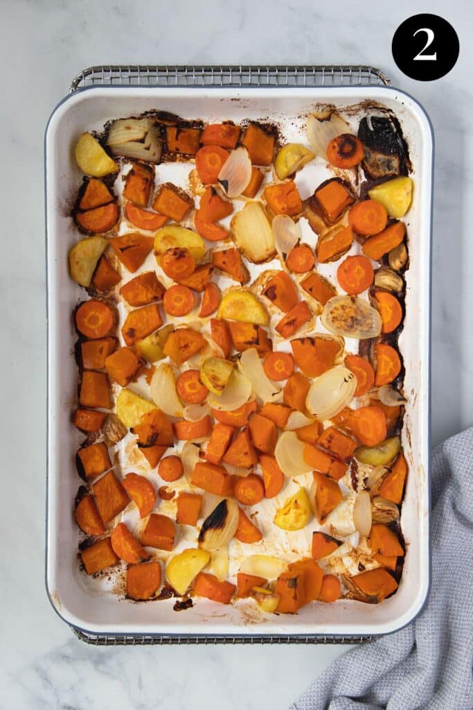 a tray of roasted vegetables with browned edges.