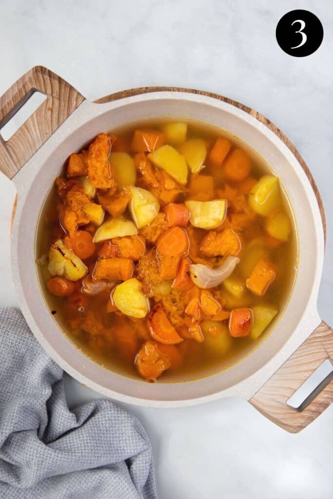 a pot of roasted vegetables in stock.