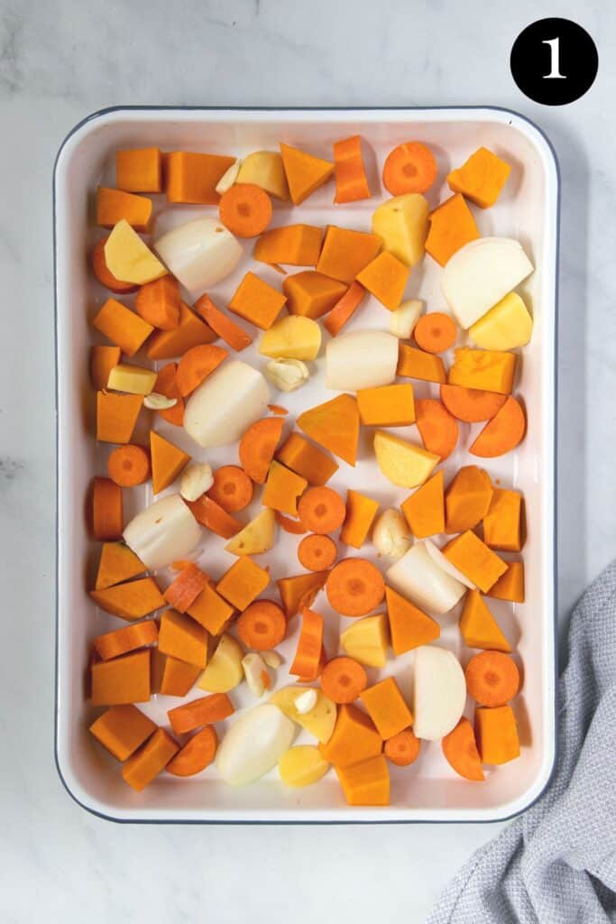 a tray of chopped vegetables including carrot and pumpkin.