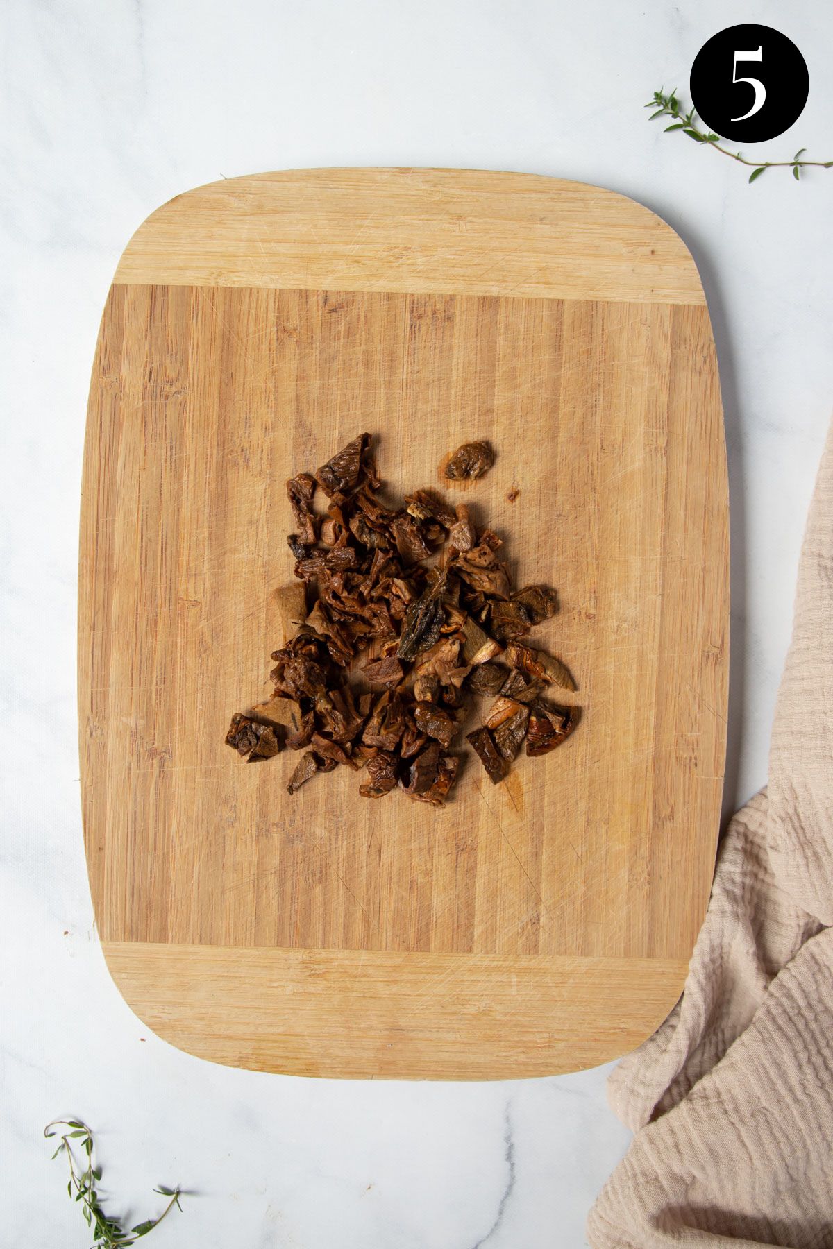 sliced porcini mushrooms on a wooden board.