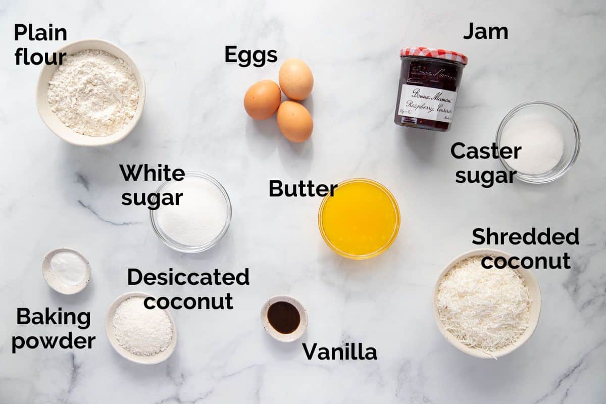 all ingredients for raspberry coconut slice, laid out on a table.