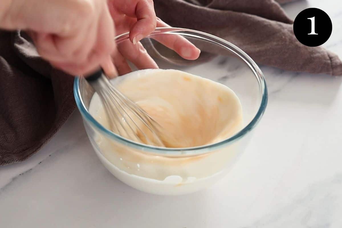 buttermilk and egg being whisked in a bowl.