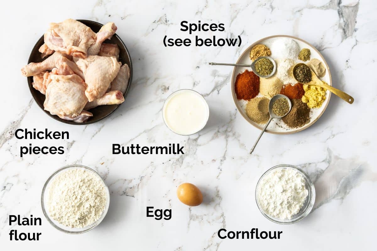 all ingredients for buttermilk fried chicken, laid out on a table.