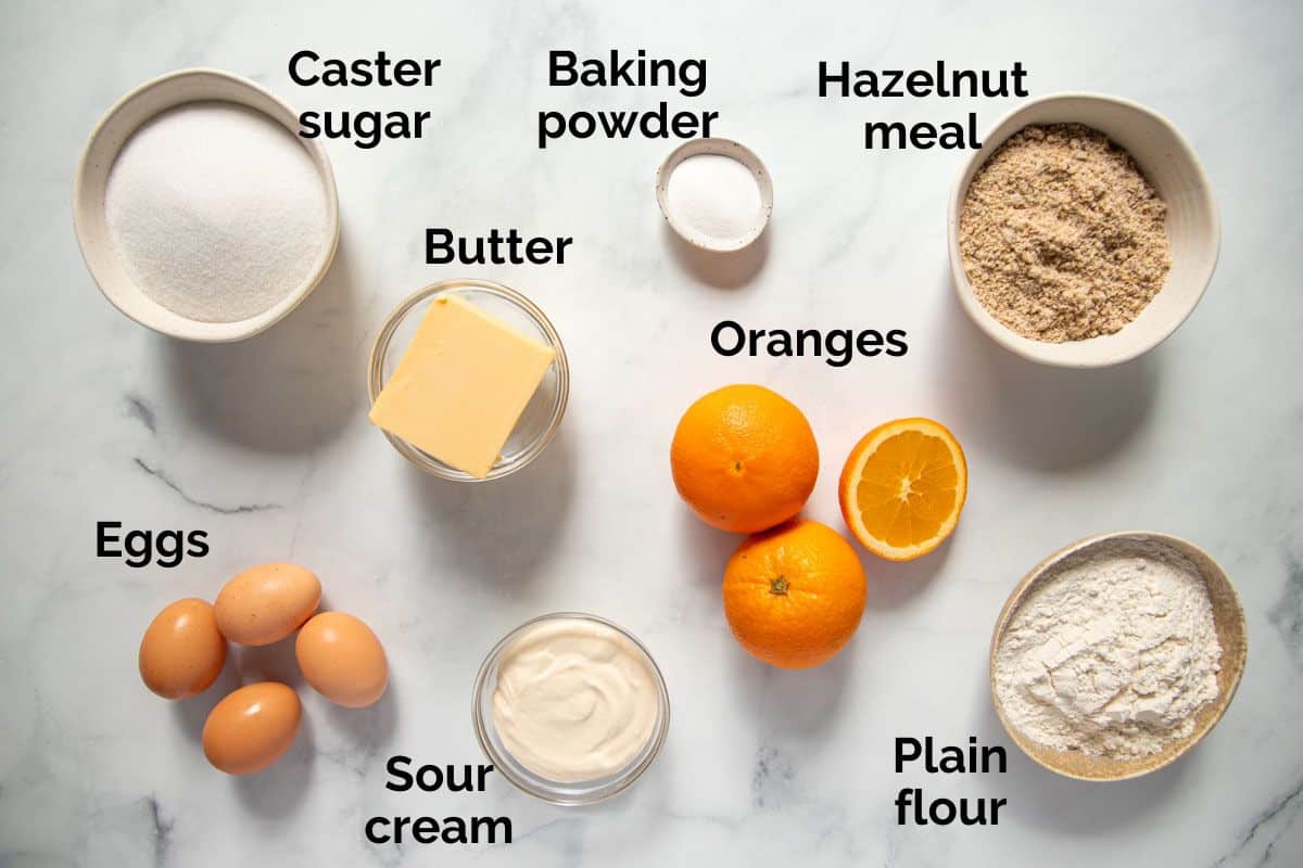all ingredients for orange syrup cake, laid out on a table.