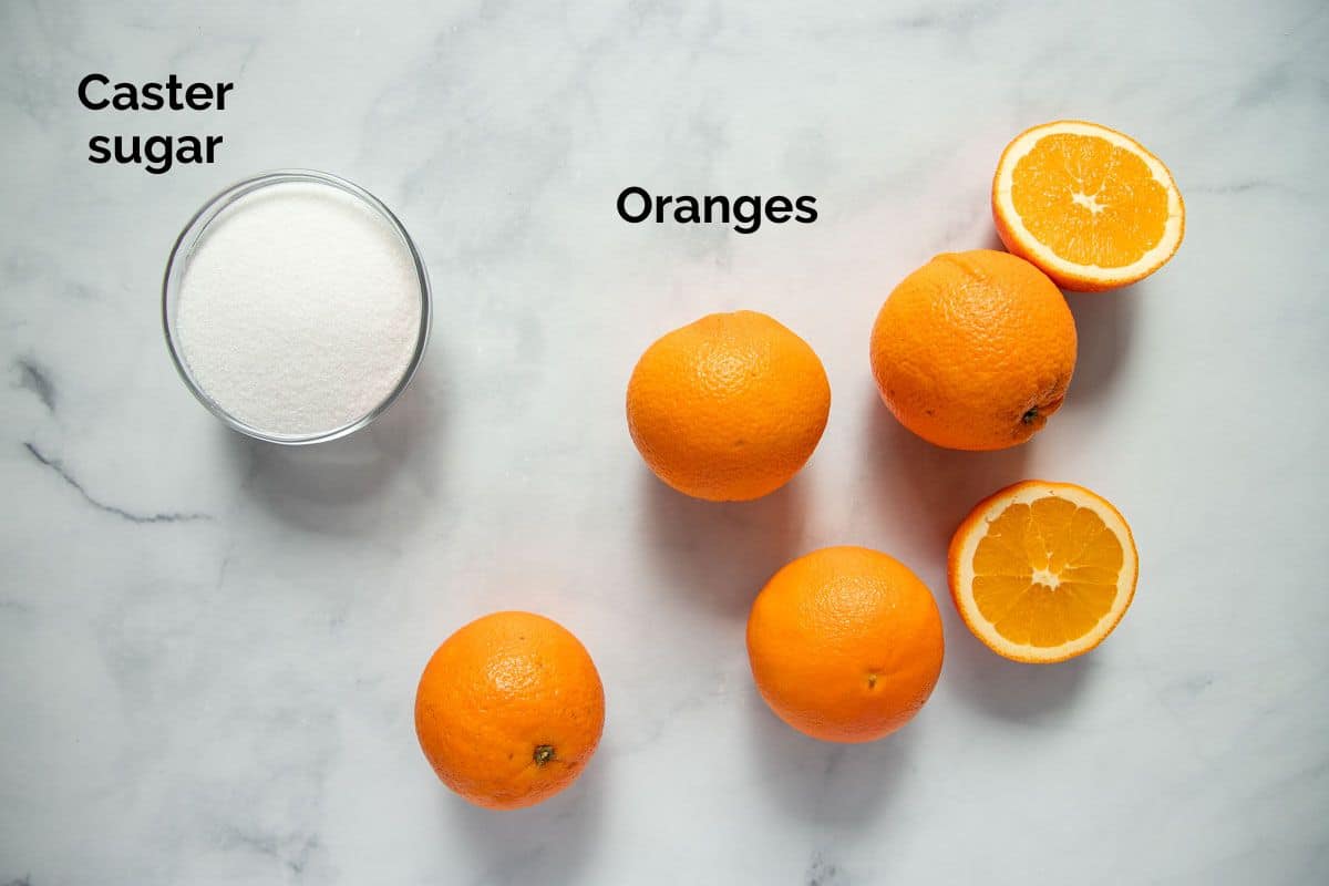 ingredients for orange simple syrup, laid out on a table.
