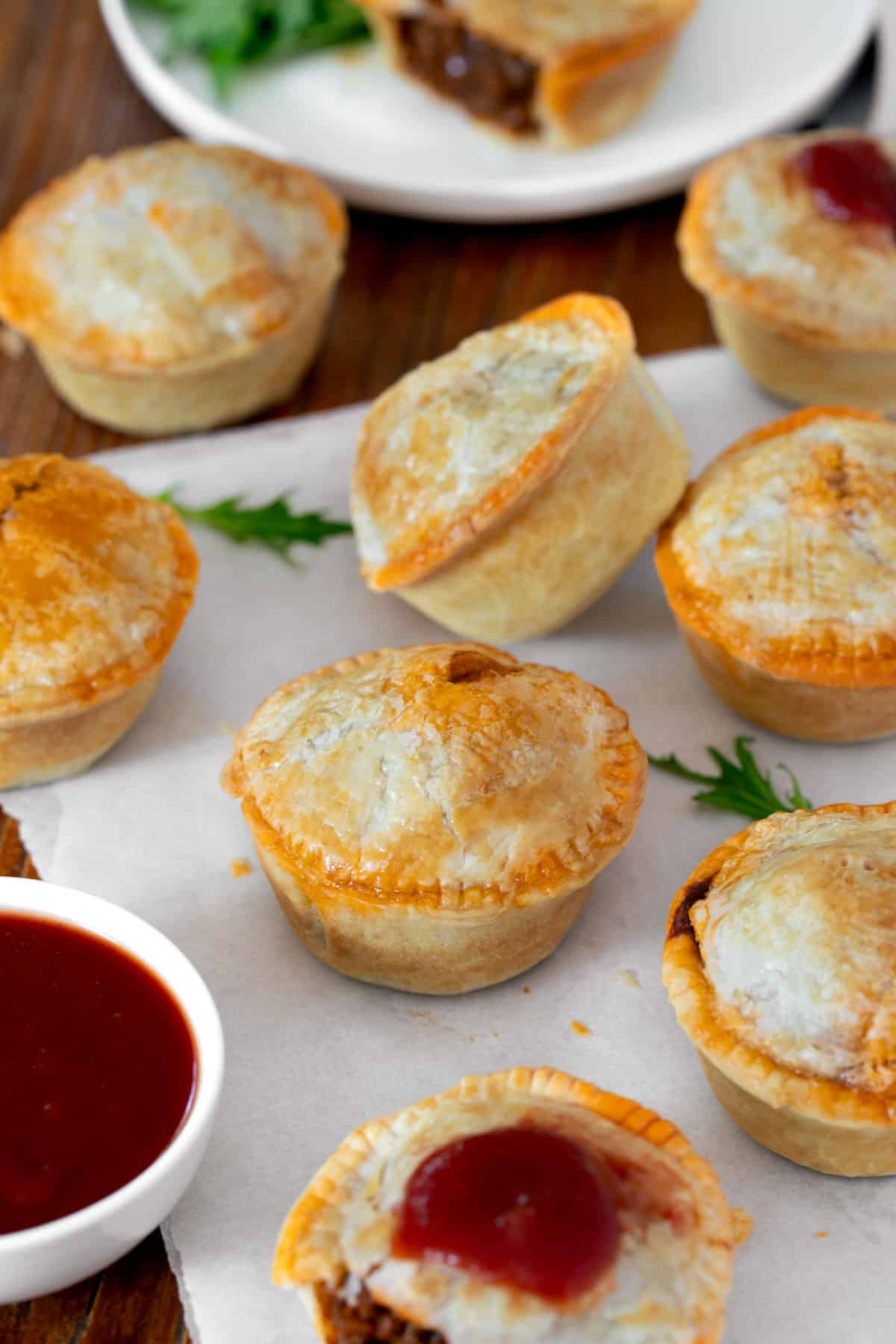 party pies on a table with tomato sauce.