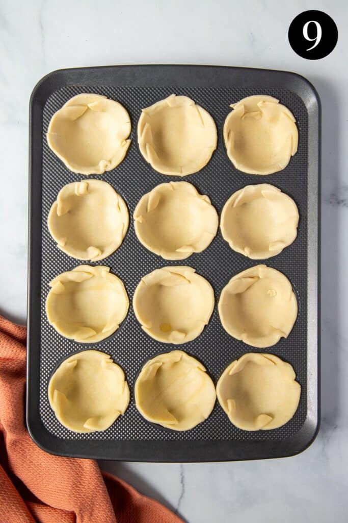 pastry bases pressed into a muffin tin.
