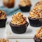 cupcakes on a board with peanuts and caramel.