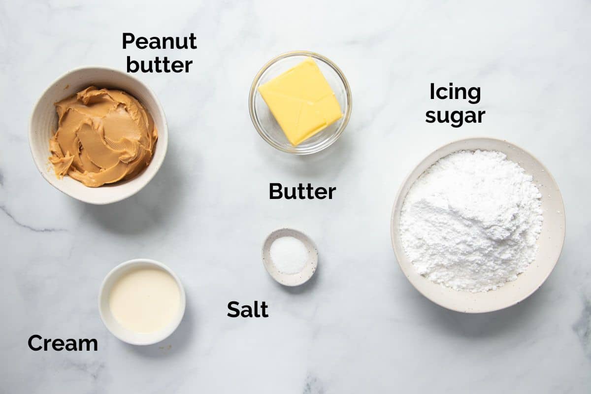 all ingredients for peanut butter frosting, laid out on a table.