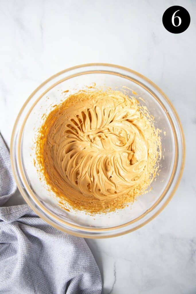 beaten peanut butter and butter mixture in a glass bowl.