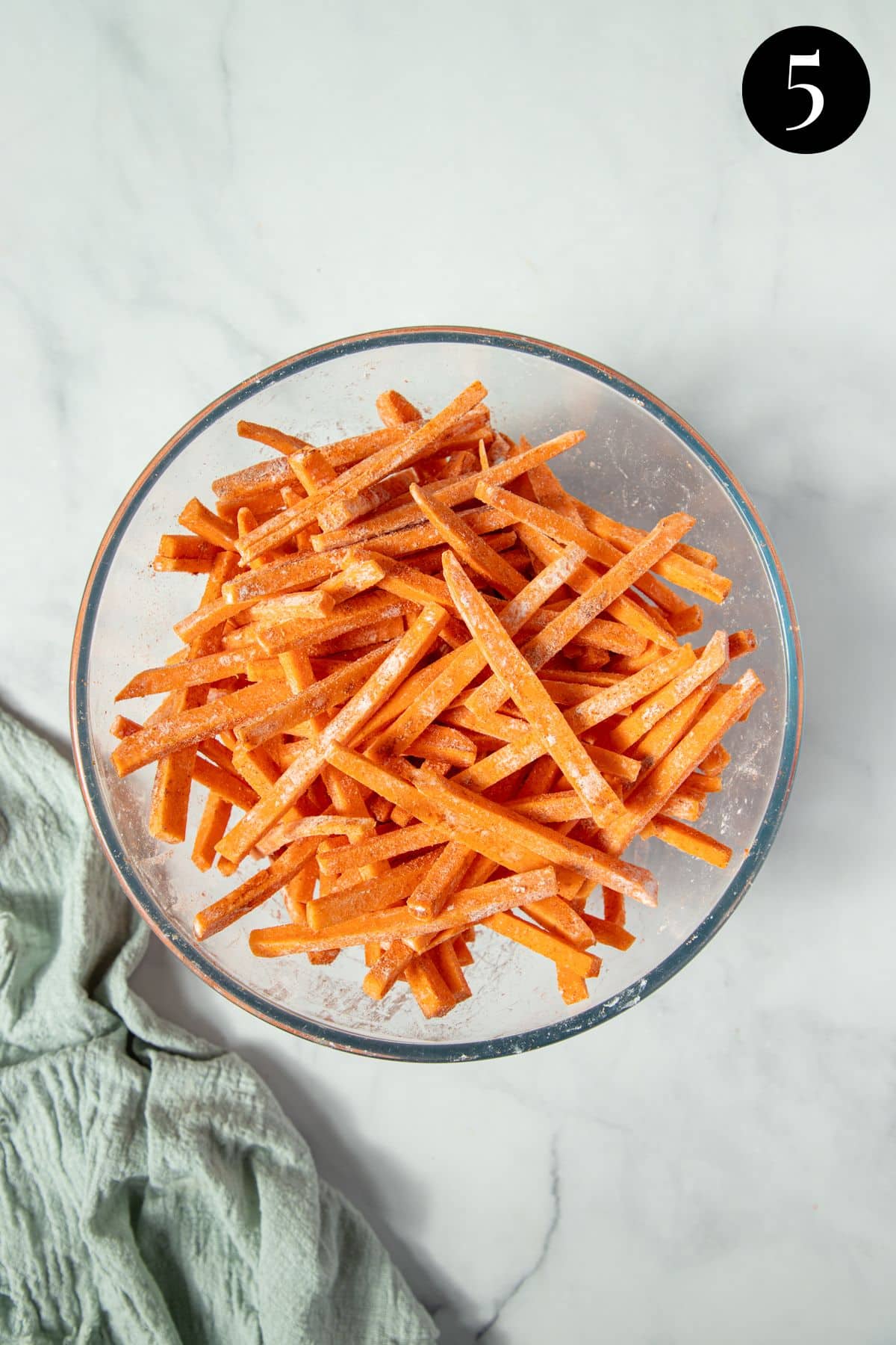 sweet potato fries in a bowl, coated in cornflour and spices.