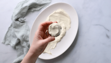 a chocolate ripple biscuit topped with whipped cream.