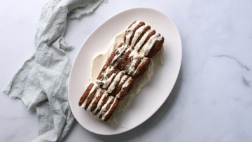 chocolate biscuits and cream arranged into a log shape on a plate.