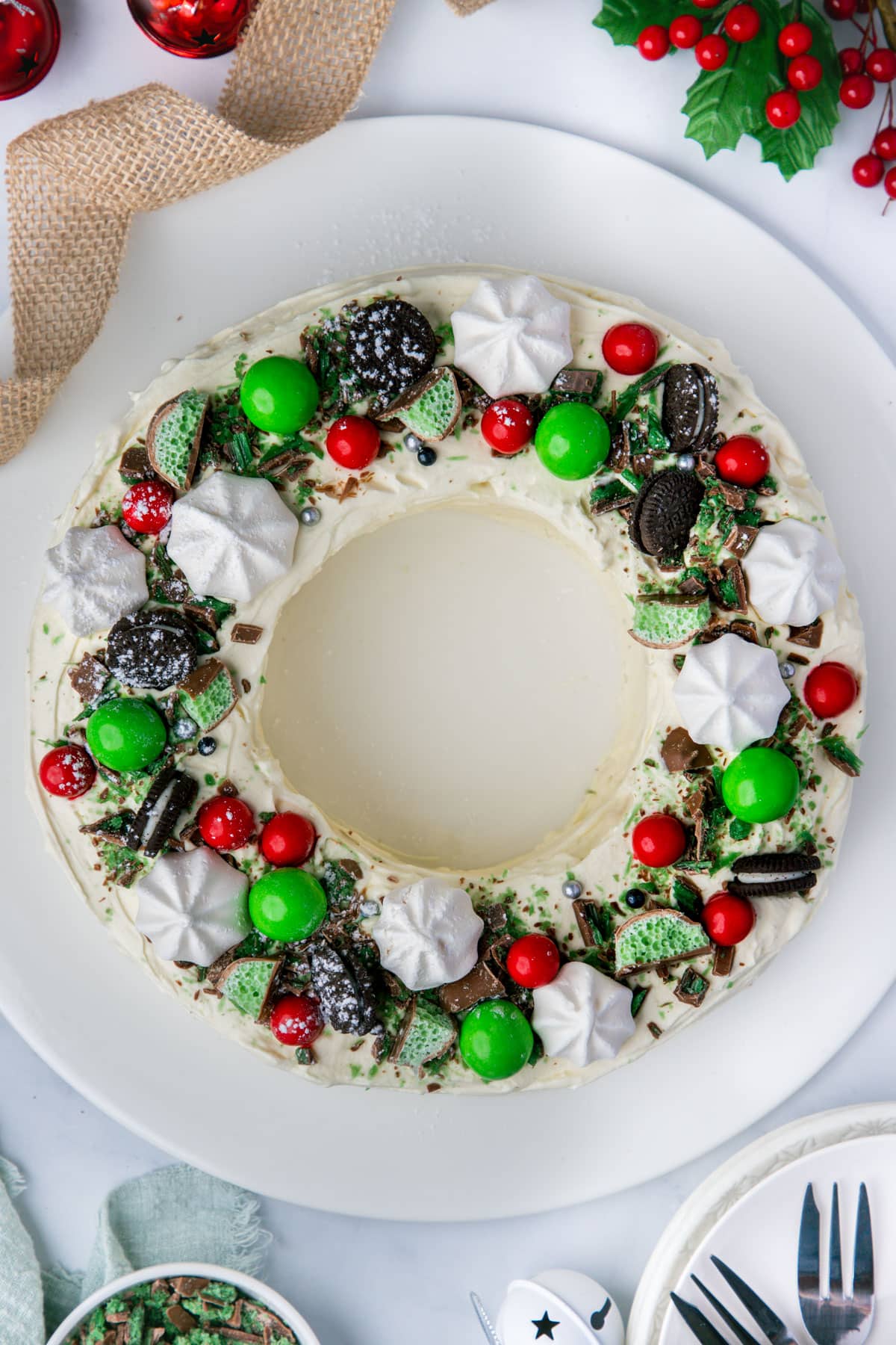 a chocolate ripple cake shaped into a wreath, topped with meringue and chocolates.