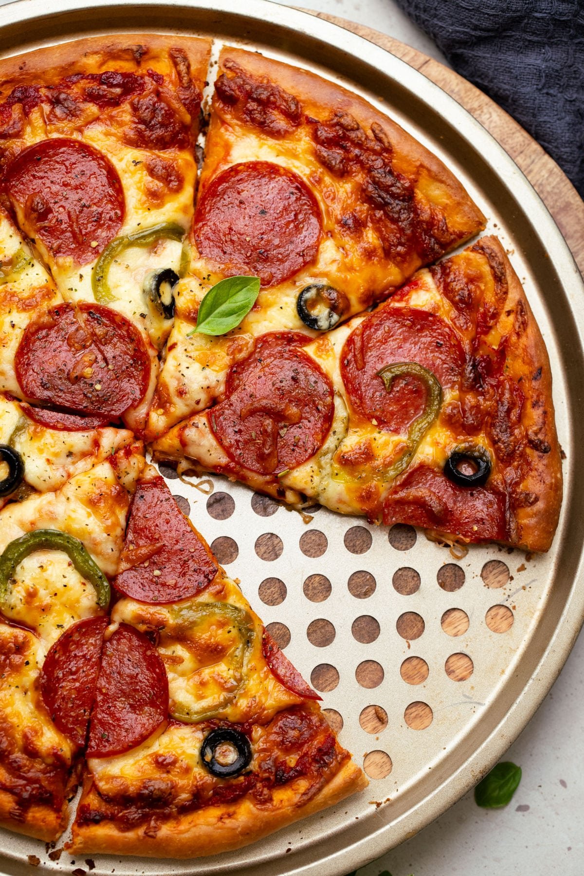 a finished pizza sliced on a round tray.