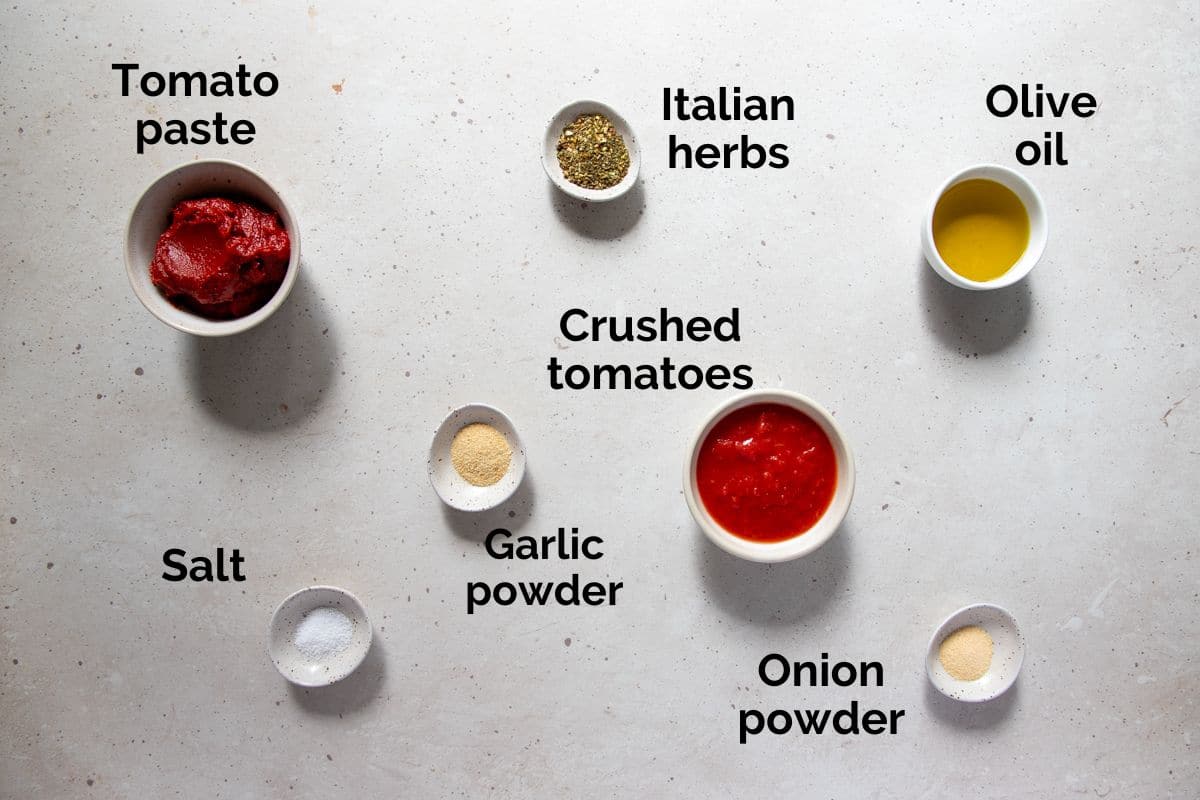 all ingredients for homemade pizza sauce, laid out on a table.