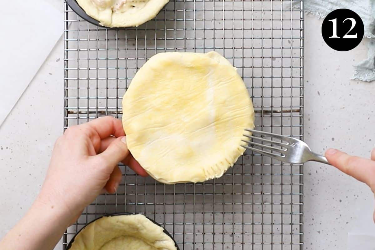 a fork pressing the edges of a pie in a tin. 