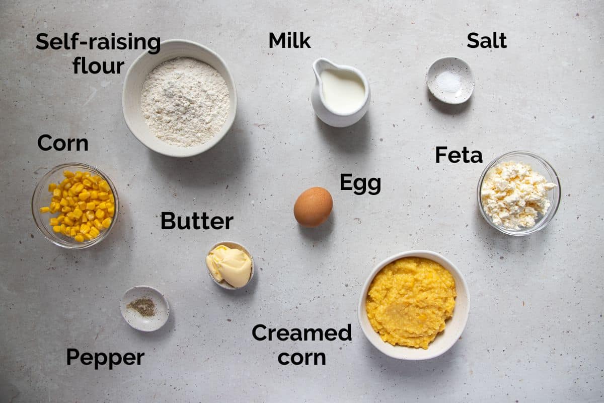 all ingredients for creamed corn fritters, laid out on a table.
