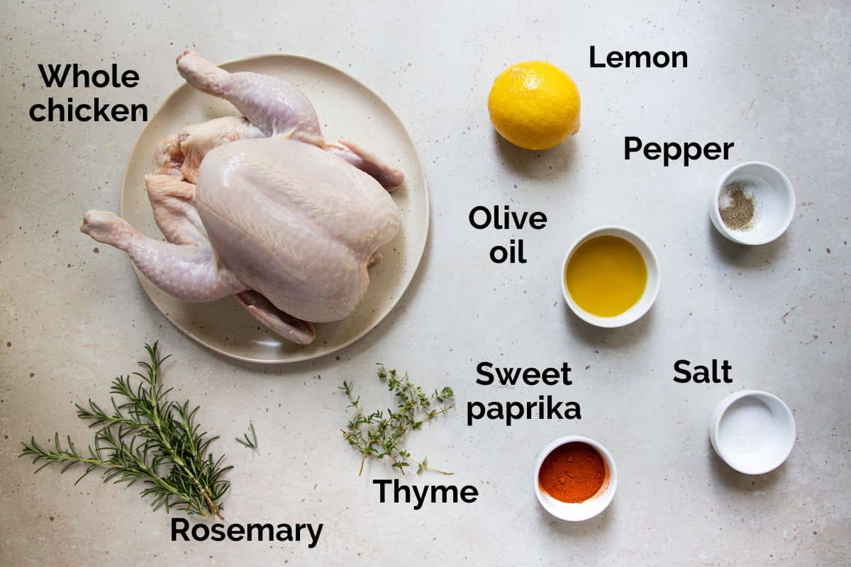 all ingredients for air fryer roast chicken, laid out on a table.