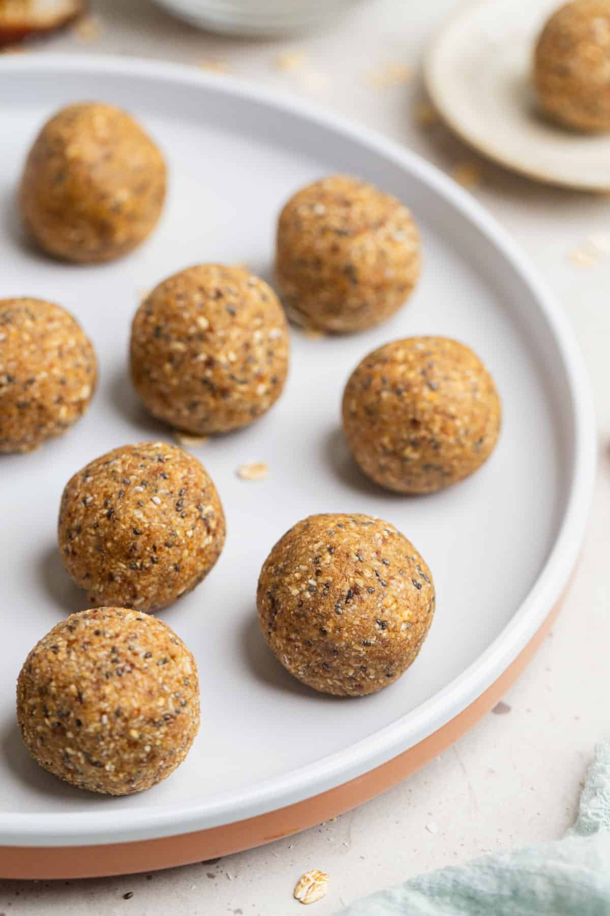 bliss balls arranged on a white plate.