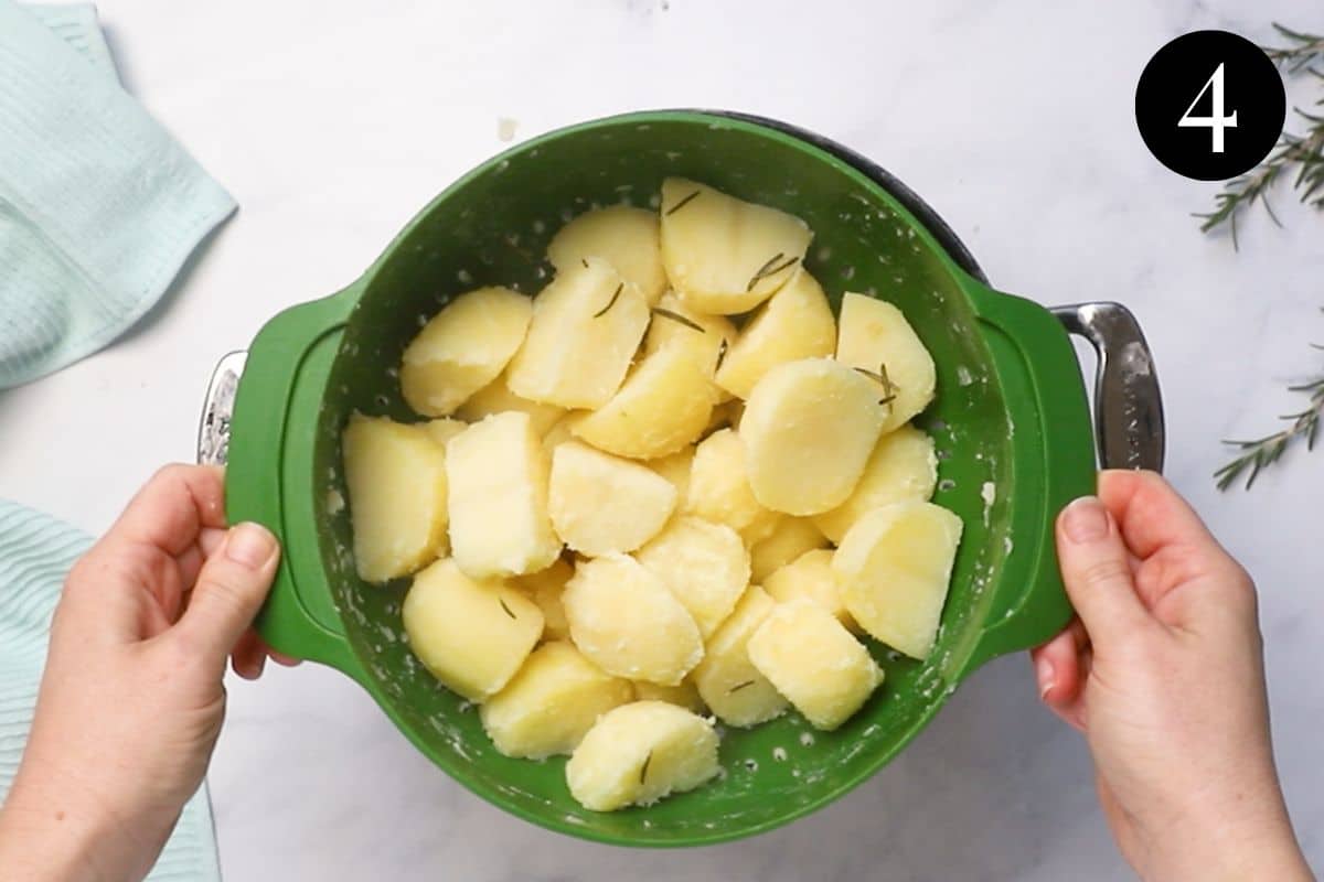 potato pieces in a colander. The potatoes are roughed up around the edges.