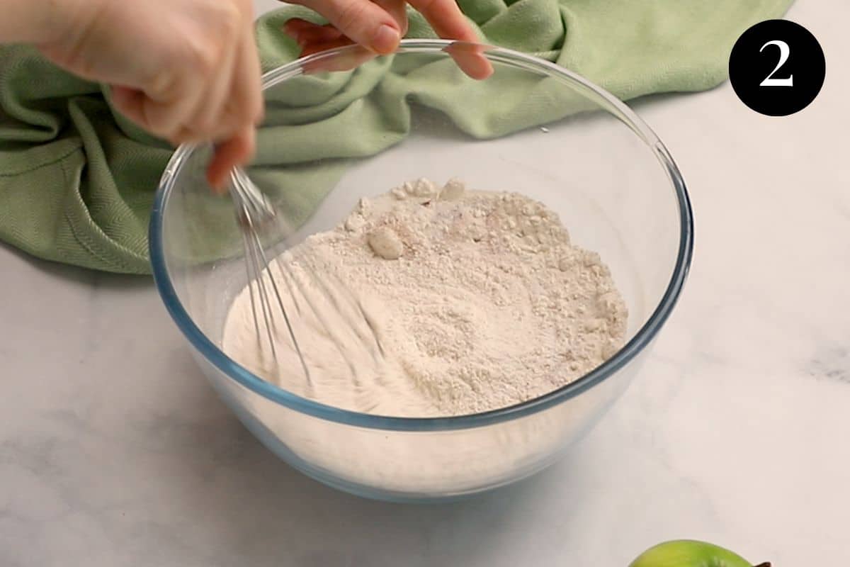 dry ingredients being whisked in a bowl.