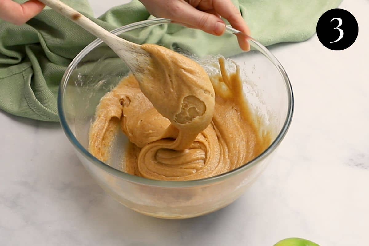 cake batter being mixed in a bowl.