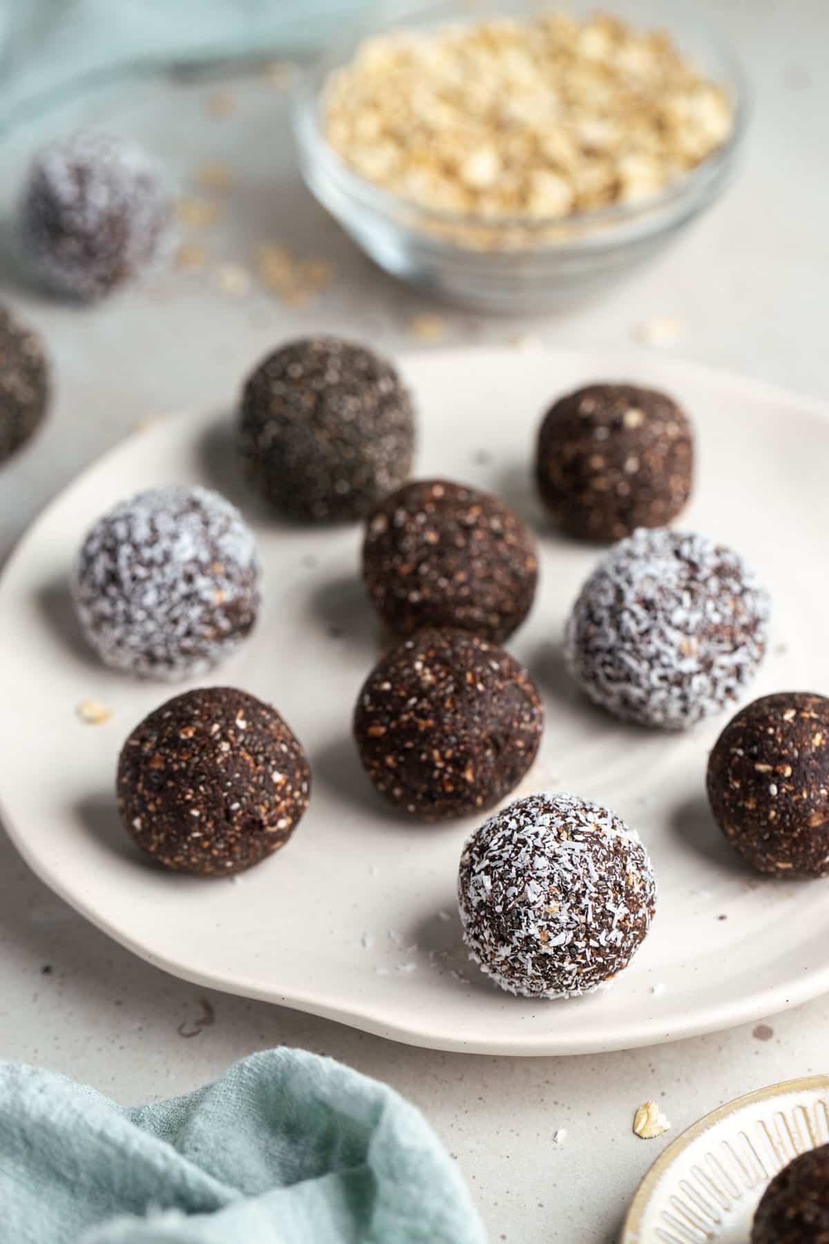 chocolate bliss balls on a white plate.