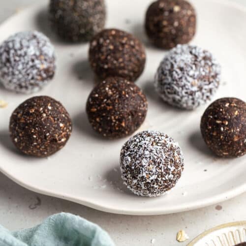 chocolate bliss balls on a white plate.
