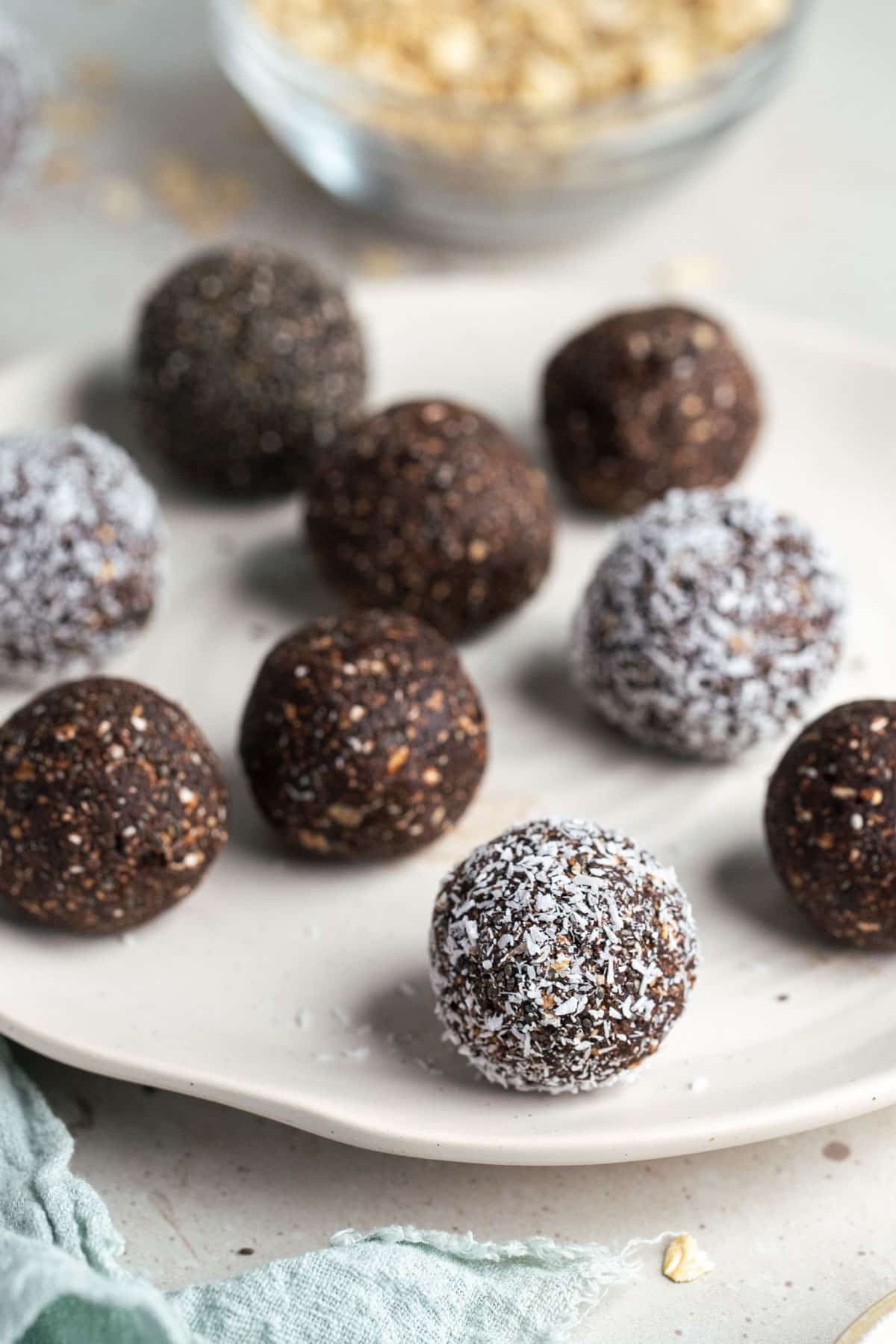 finished bliss balls on a white plate.