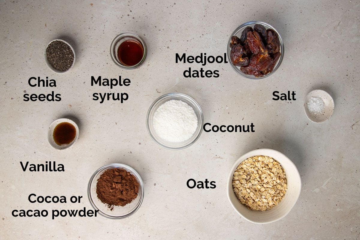 all ingredients for chocolate bliss balls, laid out on a table.