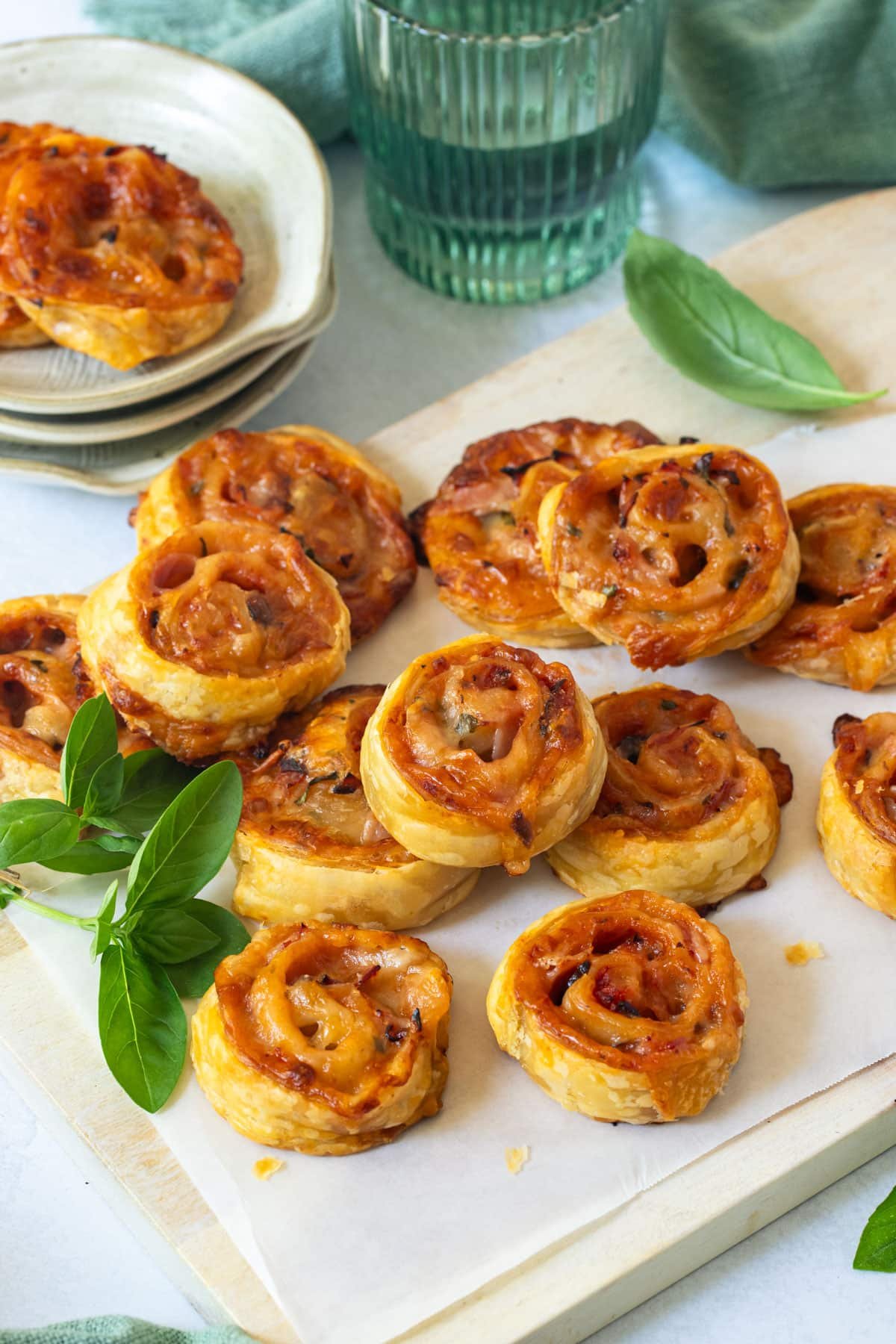 pizza scrolls on a table with basil leaves.