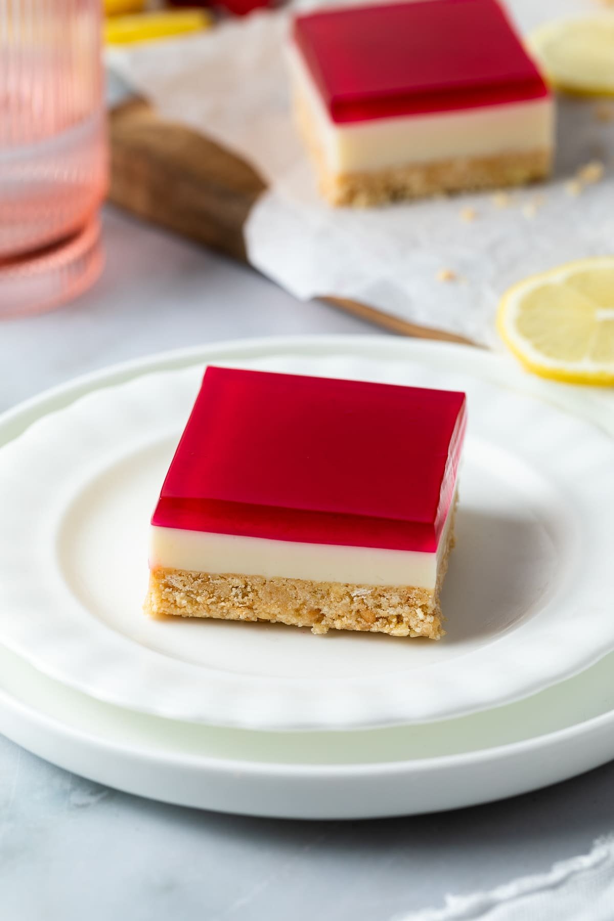 a plate with a piece of finished slice, topped with a layer of jelly.