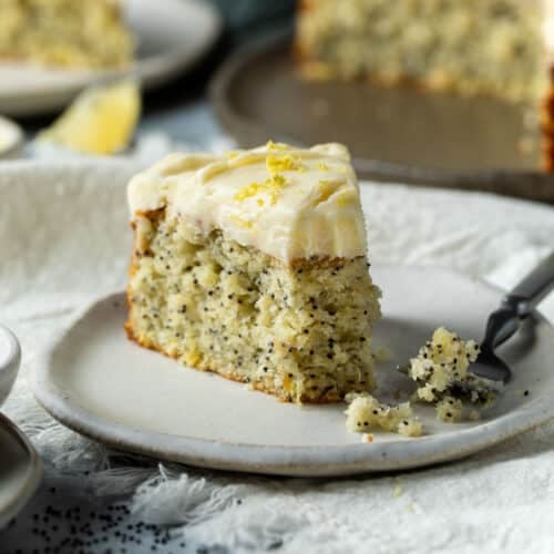 a slice of lemon poppyseed cake on a plate.