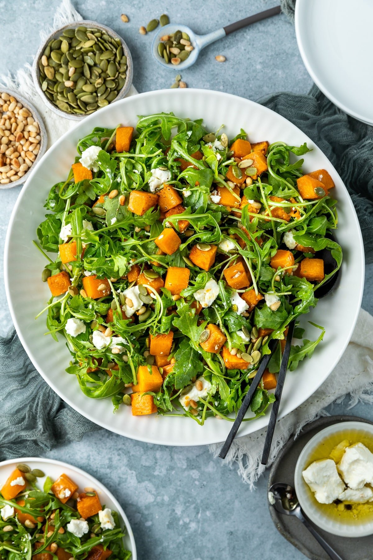 a bowl of roast pumpkin salad, on a table.