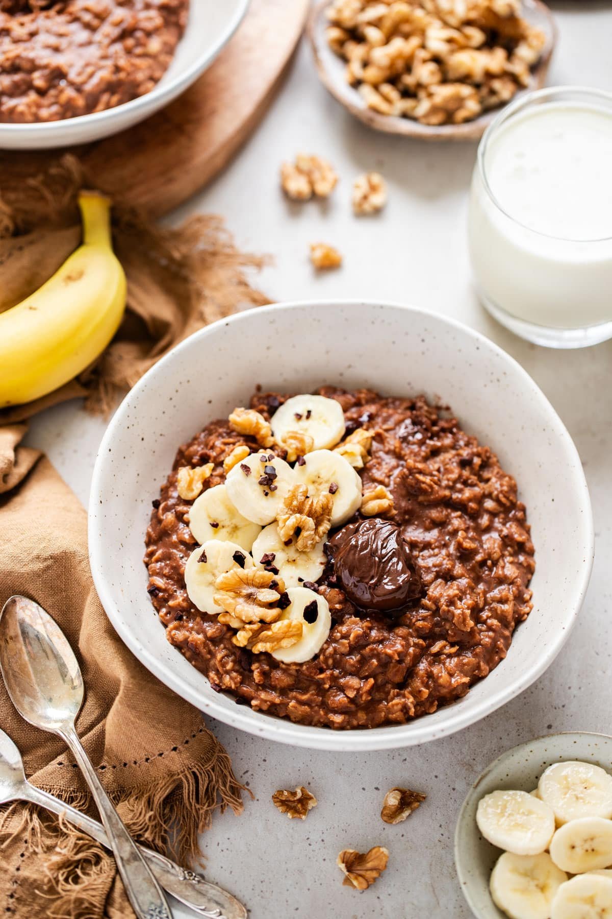 a bowl of oats topped with walnuts and banana.